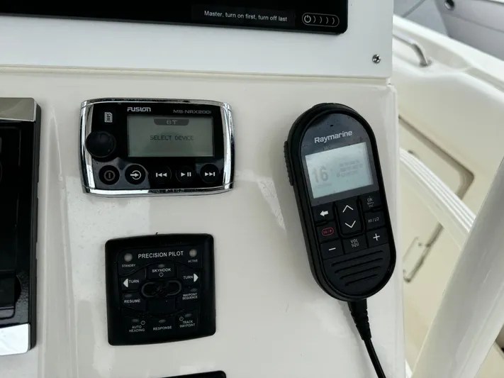 Triple Play Yacht Photos Pics Control panel of a 2015 Boston Whaler 370 Outrage with Raymarine and Fusion devices.