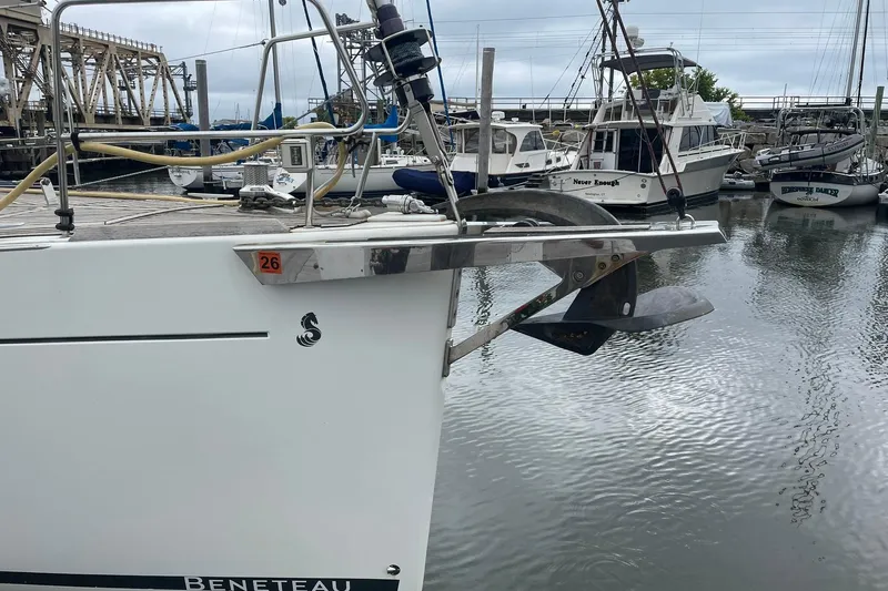 Genka Yacht Photos Pics 2017 Beneteau Sense 50 yacht anchored in a marina, showcasing its sleek design and anchor.