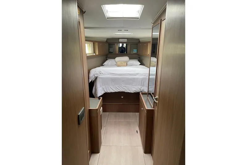 Genka Yacht Photos Pics Luxurious interior cabin of 2017 Beneteau Sense 50 yacht with cozy bed and wooden finish.