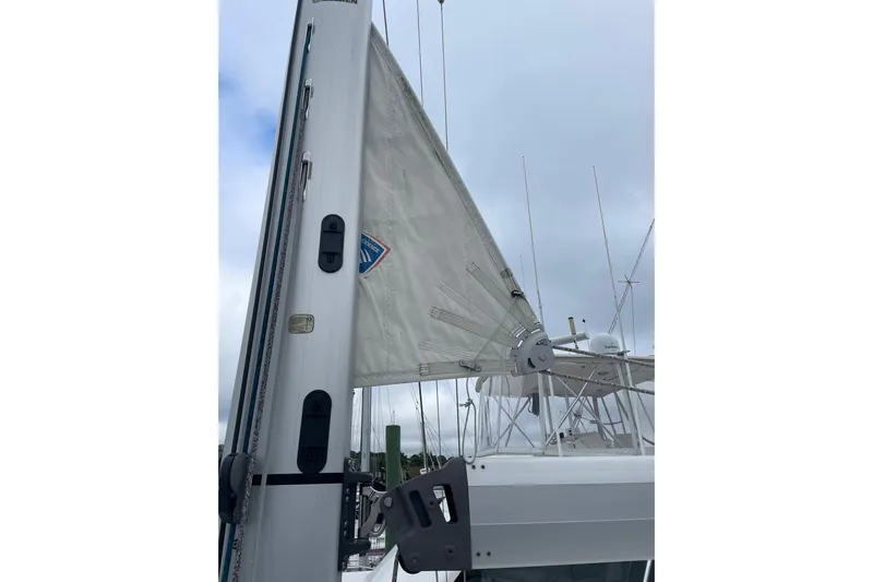 Genka Yacht Photos Pics 2017 Beneteau Sense 50 sailboat mast and sail against cloudy sky.