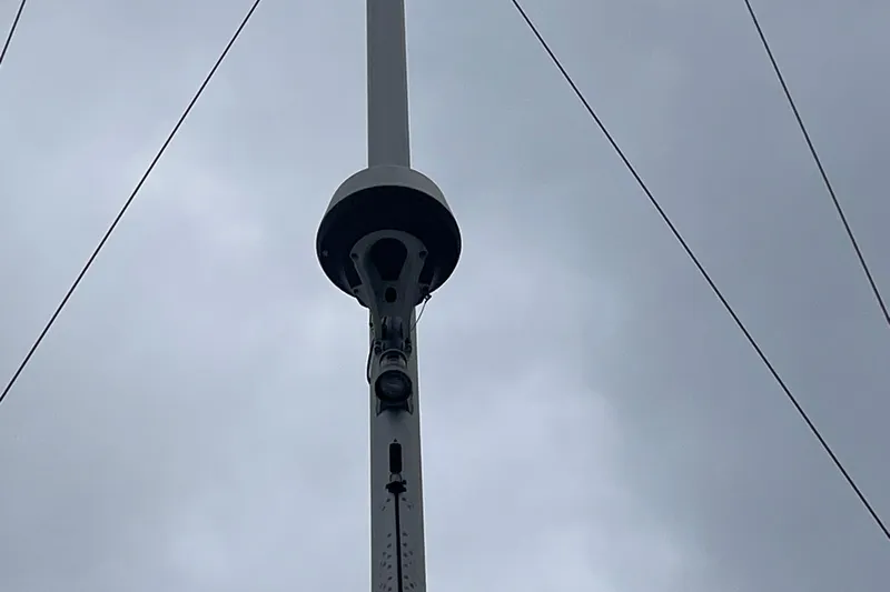 Genka Yacht Photos Pics Mast of 2017 Beneteau Sense 50 sailboat against cloudy sky.