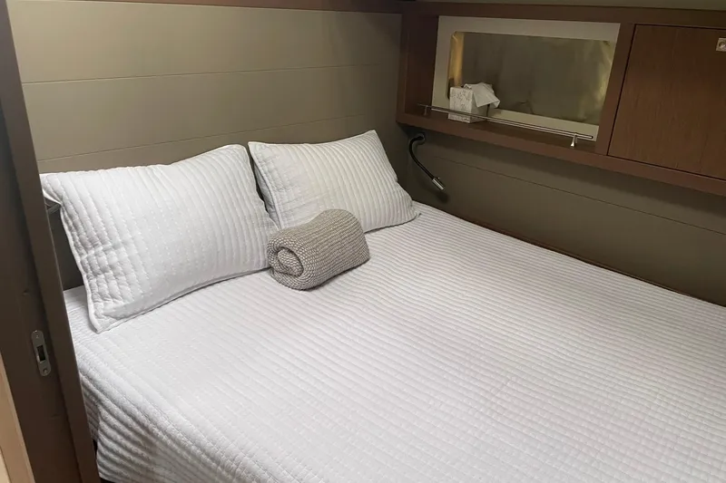 Genka Yacht Photos Pics Cozy bedroom in 2017 Beneteau Sense 50 yacht with white bedding and wooden accents.