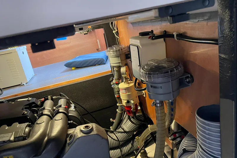 Genka Yacht Photos Pics Engine room of a 2017 Beneteau Sense 50 yacht, showcasing mechanical components and wiring.