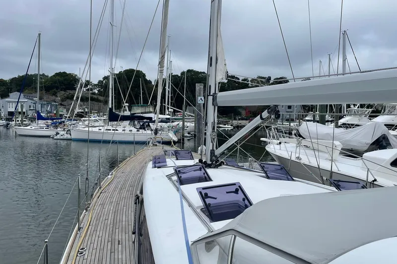 Genka Yacht Photos Pics 2017 Beneteau Sense 50 yacht docked in a marina, surrounded by other sailboats.