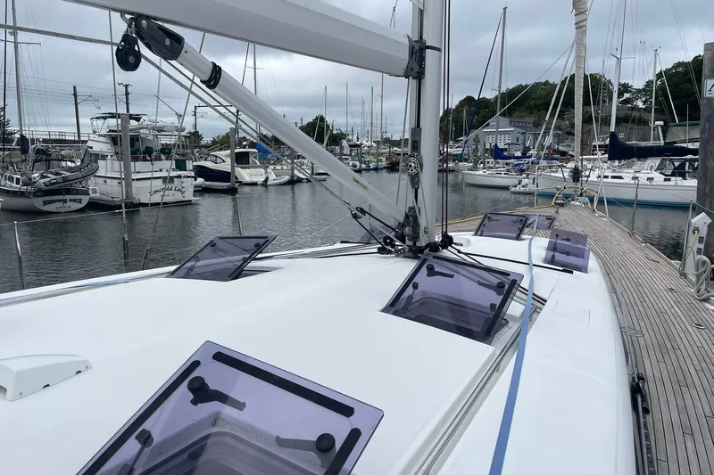 Genka Yacht Photos Pics 2017 Beneteau Sense 50 sailboat docked in a marina, showcasing deck and hatches.