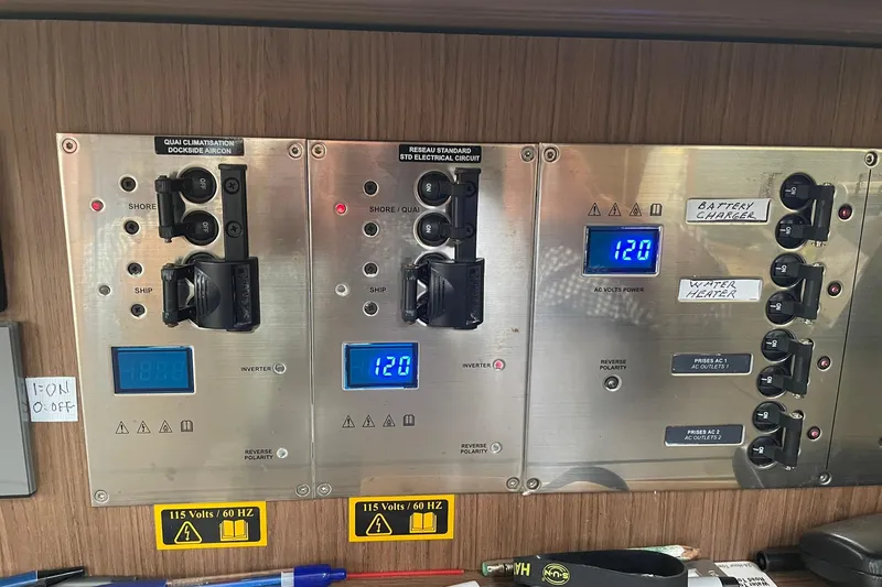 Genka Yacht Photos Pics Electrical control panel on a 2017 Beneteau Sense 50 yacht, displaying voltage and switches.