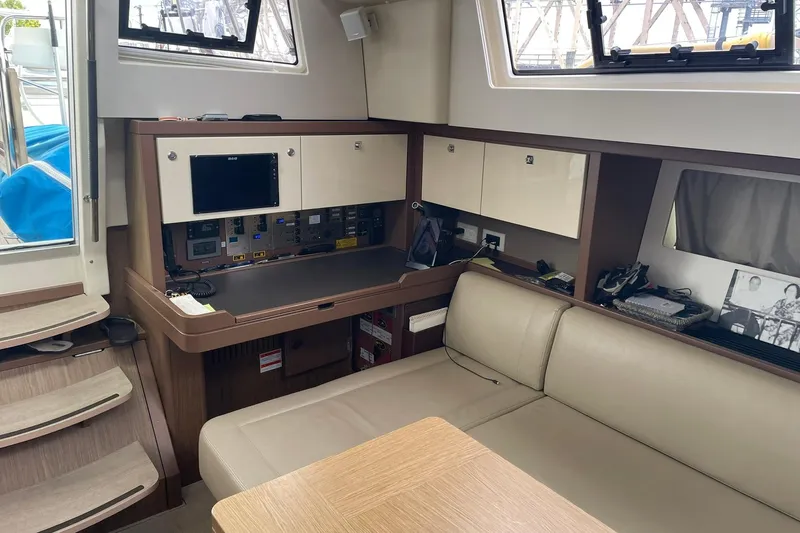 Genka Yacht Photos Pics 2017 Beneteau Sense 50 yacht interior with navigation station and seating area.