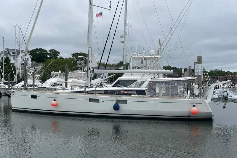 Genka Yacht Photos Pics 2017 Beneteau Sense 50 sailboat docked in a marina with overcast skies.