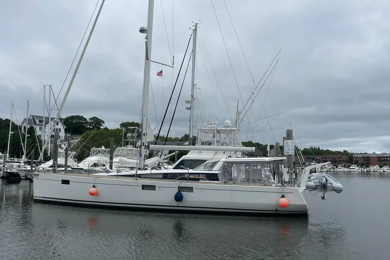 Genka Yacht Photos Pics 2017 Beneteau Sense 50 yacht docked in a marina under cloudy skies.