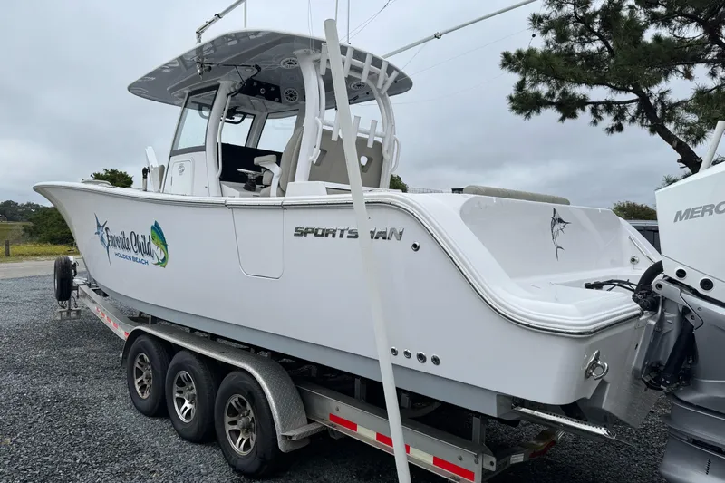  Yacht Photos Pics 2021 Sportsman Open 322 Center Console boat on trailer, side view.