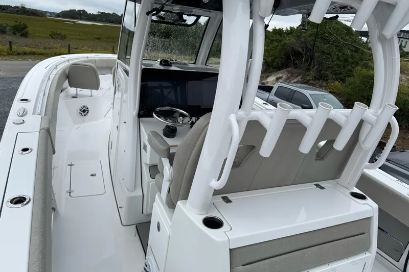  Yacht Photos Pics 2021 Sportsman Open 322 Center Console boat interior with rod holders and steering console.