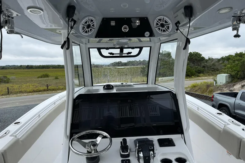  Yacht Photos Pics 2021 Sportsman Open 322 Center Console boat interior with steering wheel and control panel.