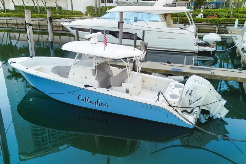  Yacht Photos Pics 2022 Cobia 350 Center Console boat docked in marina, side view.