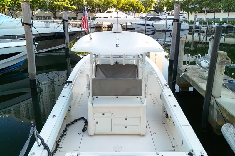  Yacht Photos Pics 2022 Cobia 350 Center Console boat docked in marina, rear view.