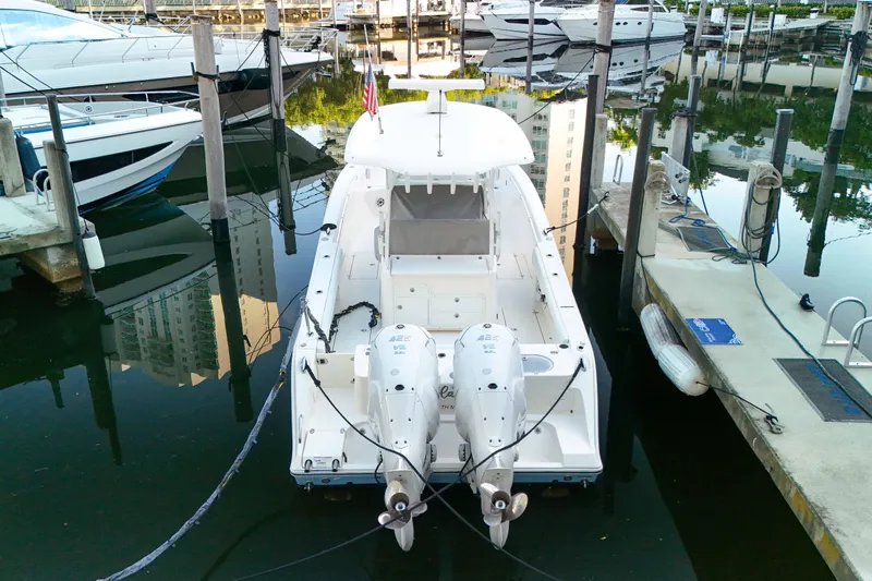  Yacht Photos Pics 2022 Cobia 350 Center Console boat docked in a marina, rear view.