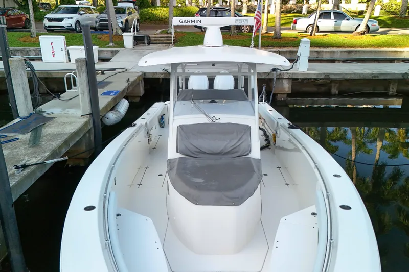  Yacht Photos Pics 2022 Cobia 350 Center Console boat docked at marina with covered seating.
