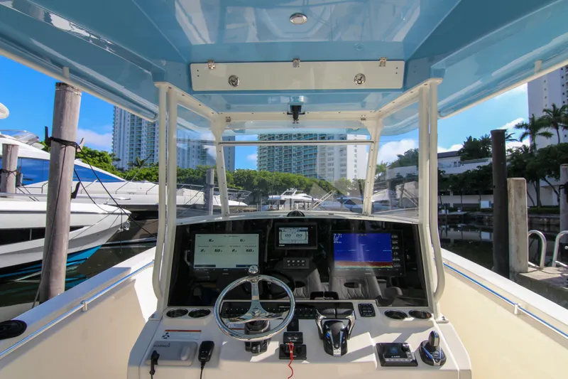 Yacht Photos Pics 2022 Cobia 350 Center Console boat dashboard with modern navigation equipment at marina.