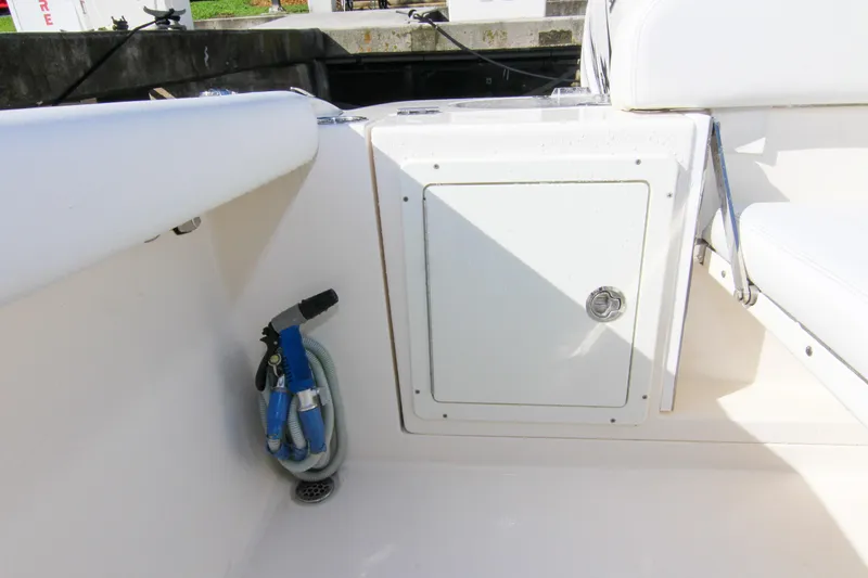  Yacht Photos Pics 2022 Cobia 350 Center Console boat interior with storage compartment and hose.