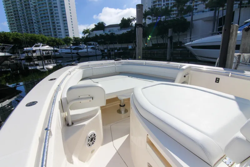  Yacht Photos Pics 2022 Cobia 350 Center Console boat interior with white seating, docked in a marina.