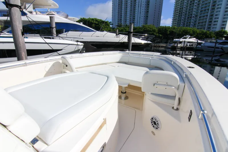  Yacht Photos Pics 2022 Cobia 350 Center Console boat interior with white seating, docked in a marina.