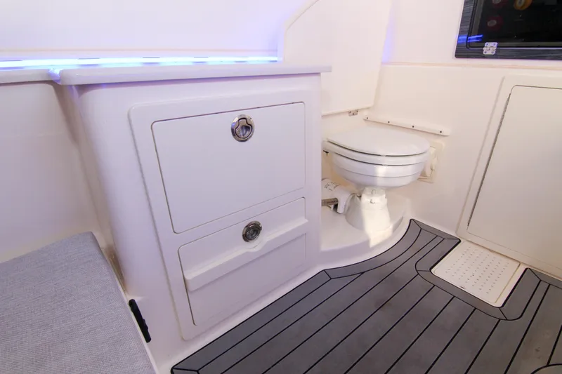  Yacht Photos Pics 2022 Cobia 350 Center Console boat interior with toilet and storage drawers.