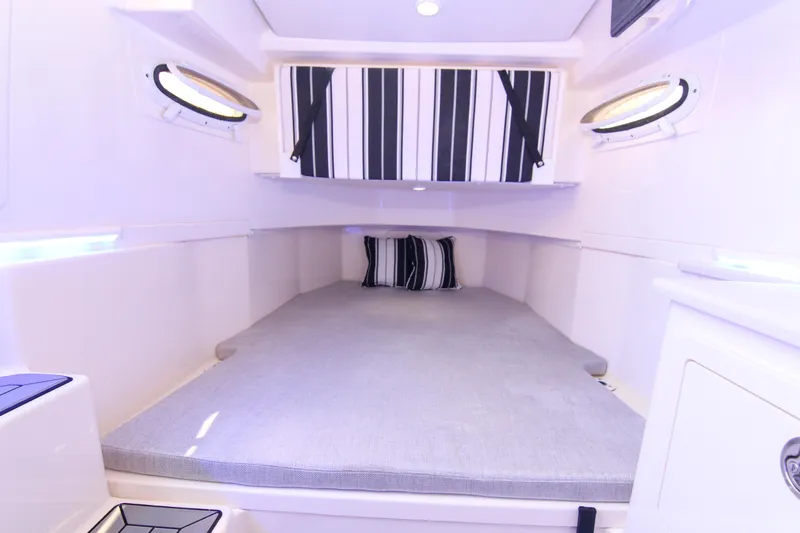  Yacht Photos Pics 2022 Cobia 350 Center Console cabin interior with striped cushions and modern design.