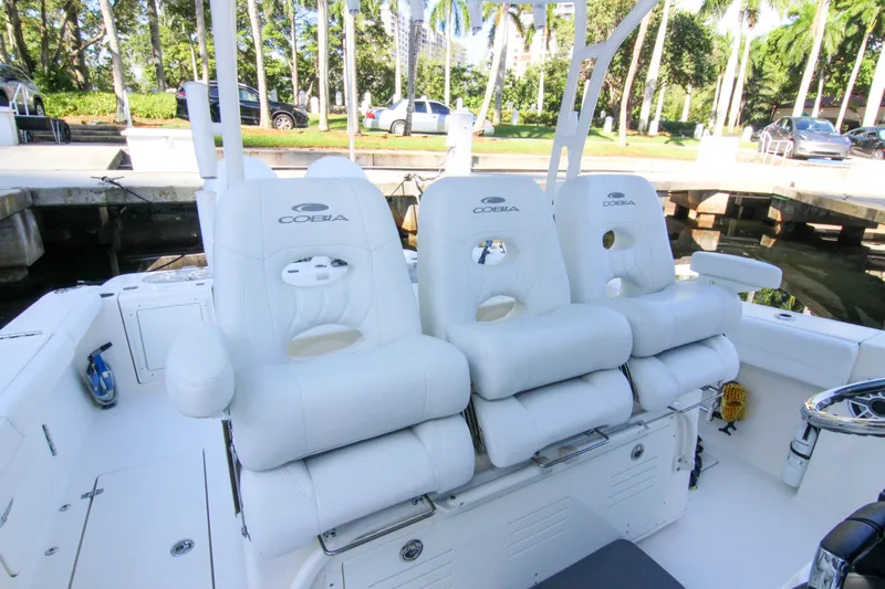  Yacht Photos Pics 2022 Cobia 350 Center Console boat with luxurious white seating at dockside.