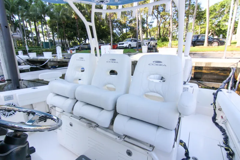  Yacht Photos Pics 2022 Cobia 350 Center Console boat with white cushioned seating and steering wheel.