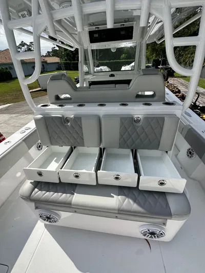  Yacht Photos Pics 2024 Onslow Bay 41 boat interior with open storage drawers and cushioned seating.