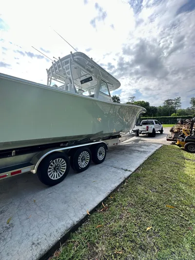  Yacht Photos Pics 2024 Onslow Bay 41 boat on trailer, parked outdoors under cloudy sky.