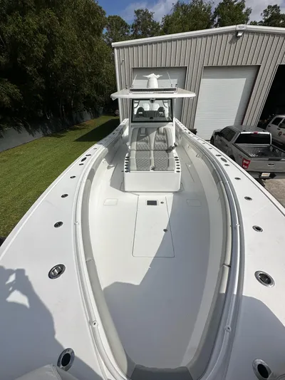  Yacht Photos Pics 2024 Onslow Bay 41 boat with sleek design, docked near a warehouse.