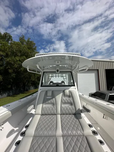  Yacht Photos Pics 2024 Onslow Bay 41 boat with luxurious seating and sleek design under a partly cloudy sky.