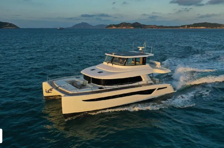 Bikini Sunset Yacht Photos Pics Luxurious Granocean 57 yacht 2023 cruising on open sea at sunset.