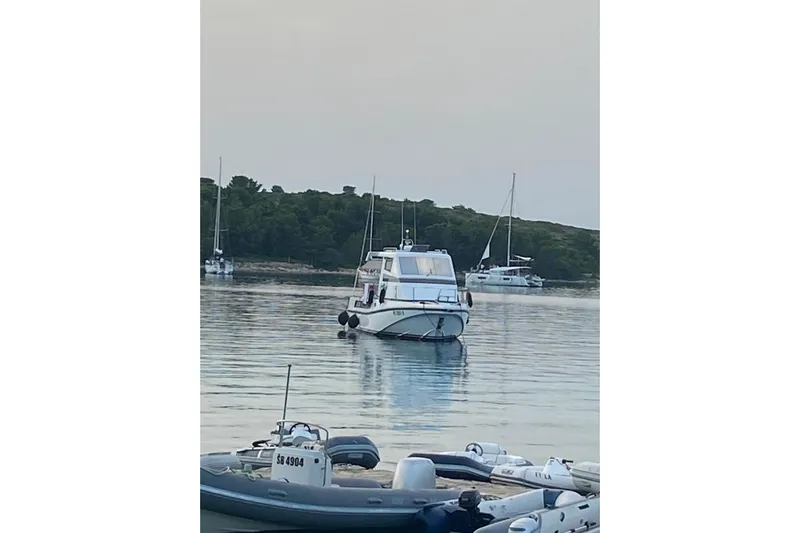 Captain Back Yacht Photos Pics 1988 Cantiere Navale di Pesaro Studio Mare Atmosfere 46 yacht anchored in serene waters.