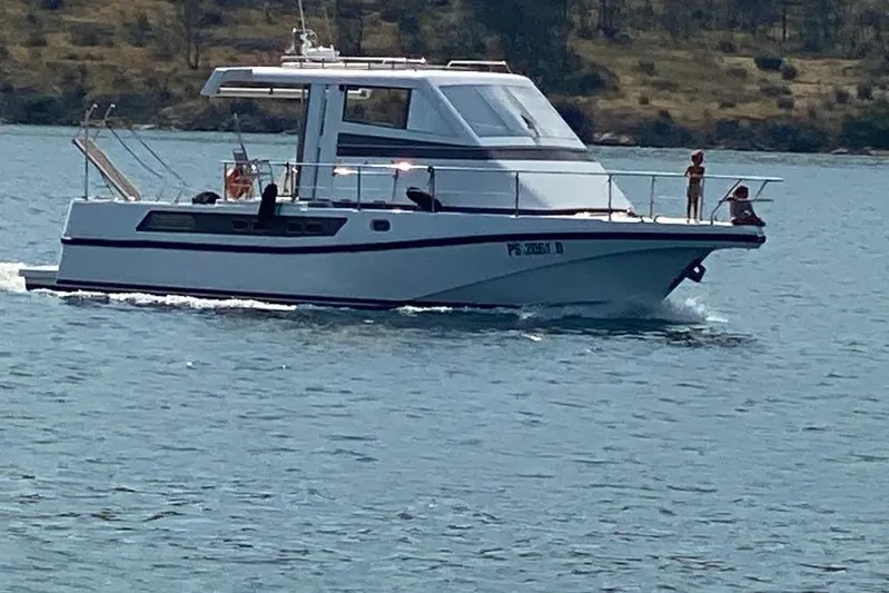 Captain Back Yacht Photos Pics 1988 Cantiere Navale di Pesaro Studio Mare Atmosfere 46 yacht cruising on a calm sea.