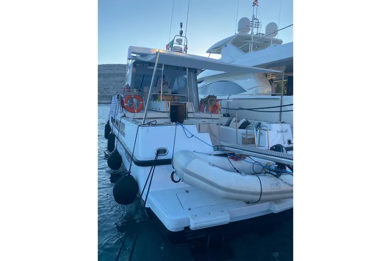 Captain Back Yacht Photos Pics 1988 Cantiere Navale di Pesaro Studio Mare Atmosfere 46 yacht docked, with inflatable boat attached.