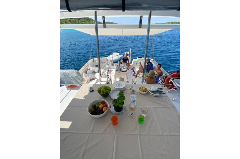 Captain Back Yacht Photos Pics People dining on a 1988 Studio Mare Atmosfere 46 yacht, enjoying a sunny day at sea.