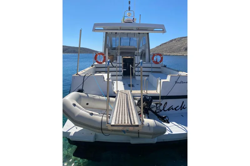 Captain Back Yacht Photos Pics 1988 Cantiere Navale di Pesaro Studio Mare Atmosfere 46 yacht with dinghy and boarding ramp.