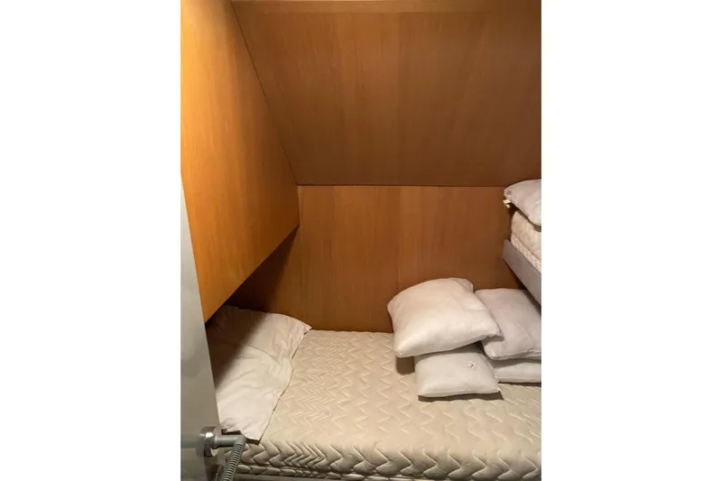 Captain Back Yacht Photos Pics Cozy cabin interior of 1988 Studio Mare Atmosfere 46 yacht with wooden walls and bedding.