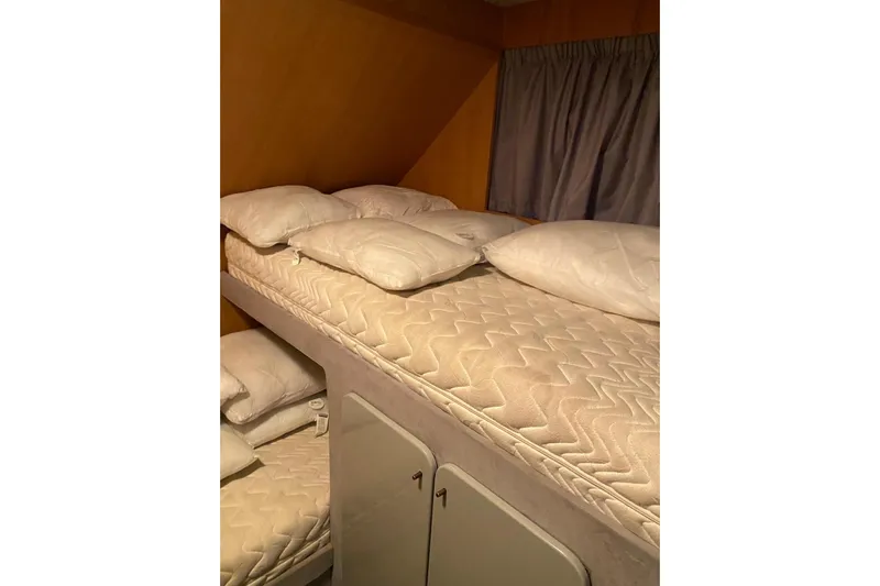 Captain Back Yacht Photos Pics Interior of 1988 Studio Mare Atmosfere 46 yacht with bunk beds and pillows.