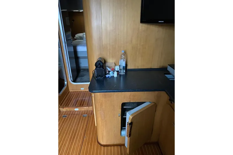 Captain Back Yacht Photos Pics Interior of 1988 Studio Mare Atmosfere 46 yacht with wooden cabinetry and open door.