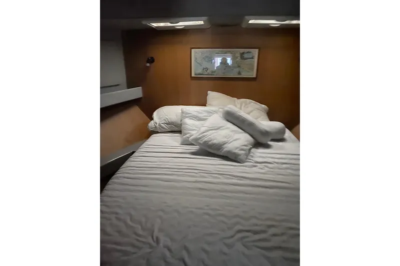 Captain Back Yacht Photos Pics Cozy cabin interior of 1988 Studio Mare Atmosfere 46 yacht with bed and wall art.