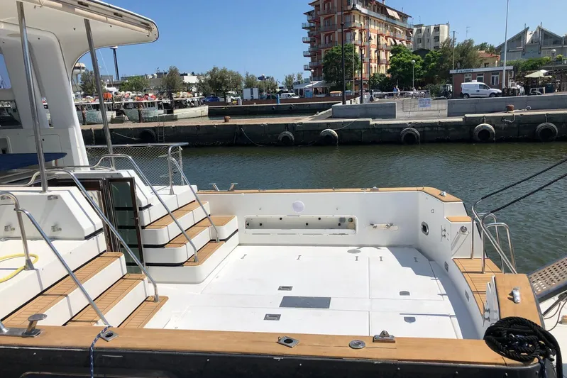 Captain Back Yacht Photos Pics Luxury yacht deck of 1988 Studio Mare Atmosfere 46 in a marina setting.