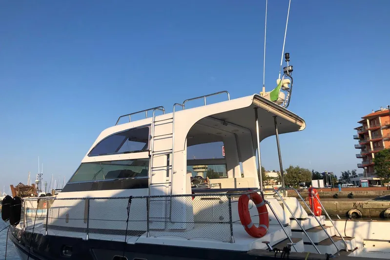 Captain Back Yacht Photos Pics 1988 Cantiere Navale di Pesaro Studio Mare Atmosfere 46 yacht docked under clear blue sky.
