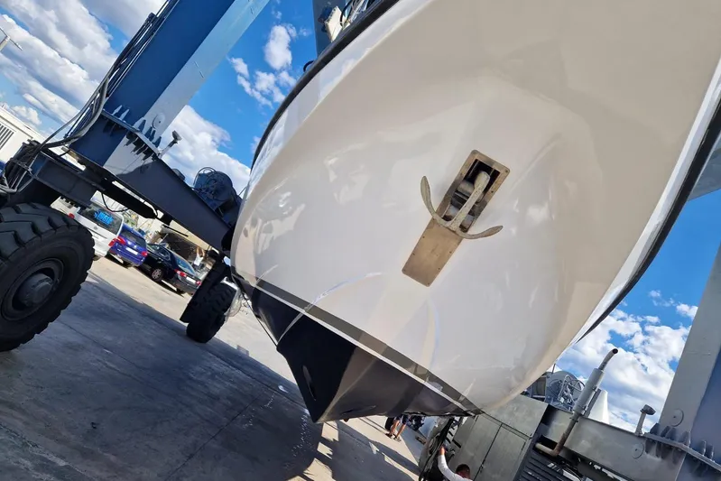 Captain Back Yacht Photos Pics Studio Mare Atmosfere 46 yacht, 1988 model, on a lift under a clear blue sky.