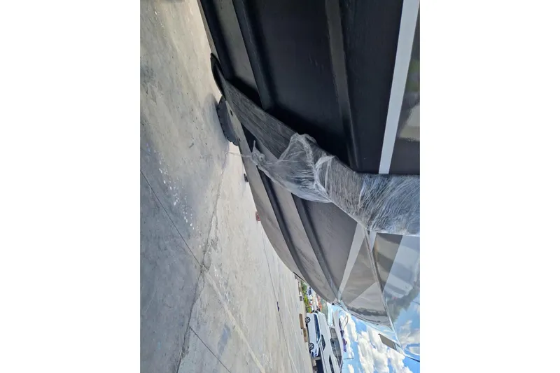 Captain Back Yacht Photos Pics 1988 Studio Mare Atmosfere 46 yacht hull wrapped in protective material on a concrete surface.