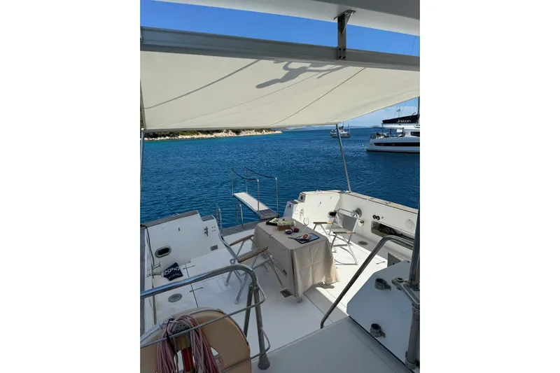 Captain Back Yacht Photos Pics Sailing yacht Studio Mare Atmosfere 46, 1988, with shaded deck and ocean view.