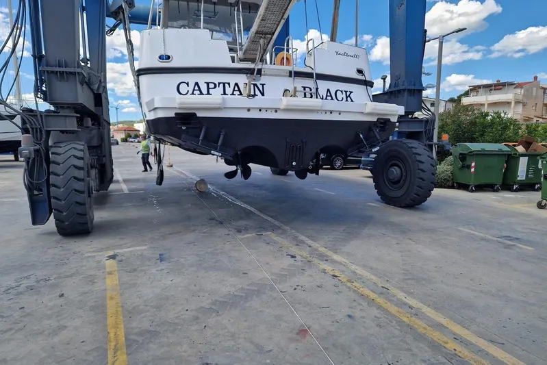Captain Back Yacht Photos Pics Boat "Captain Black" lifted by crane, Studio Mare Atmosfere 46, 1988 model, in a shipyard.