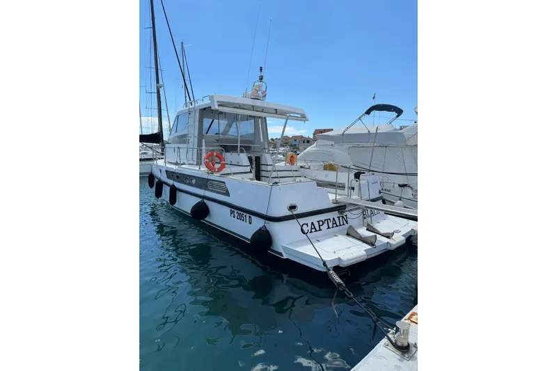 Captain Back Yacht Photos Pics Studio Mare Atmosfere 46 yacht, 1988 model, docked in a marina.