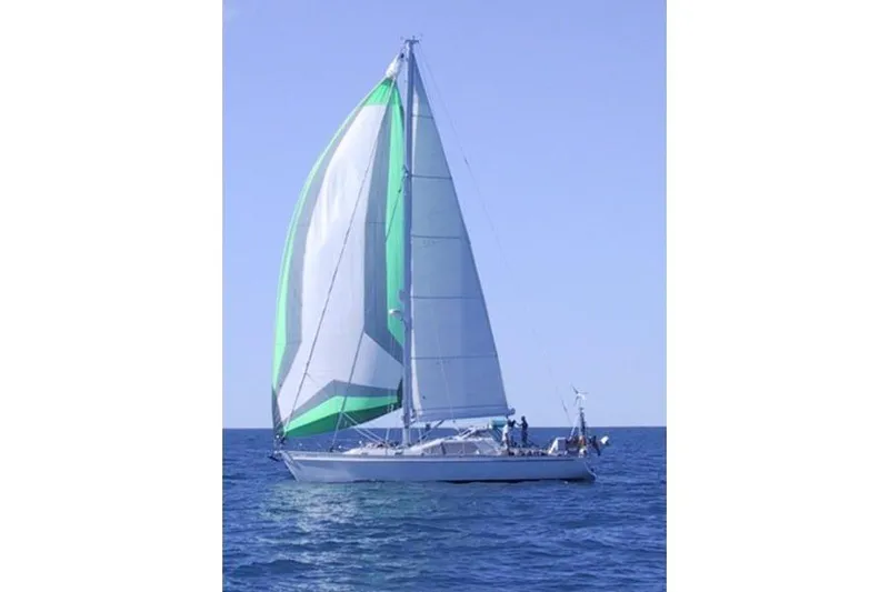 Raynad Yacht Photos Pics Sailing yacht "World Cruiser" by Custom Steel Cutter, 2000, with green and white sails on open sea.